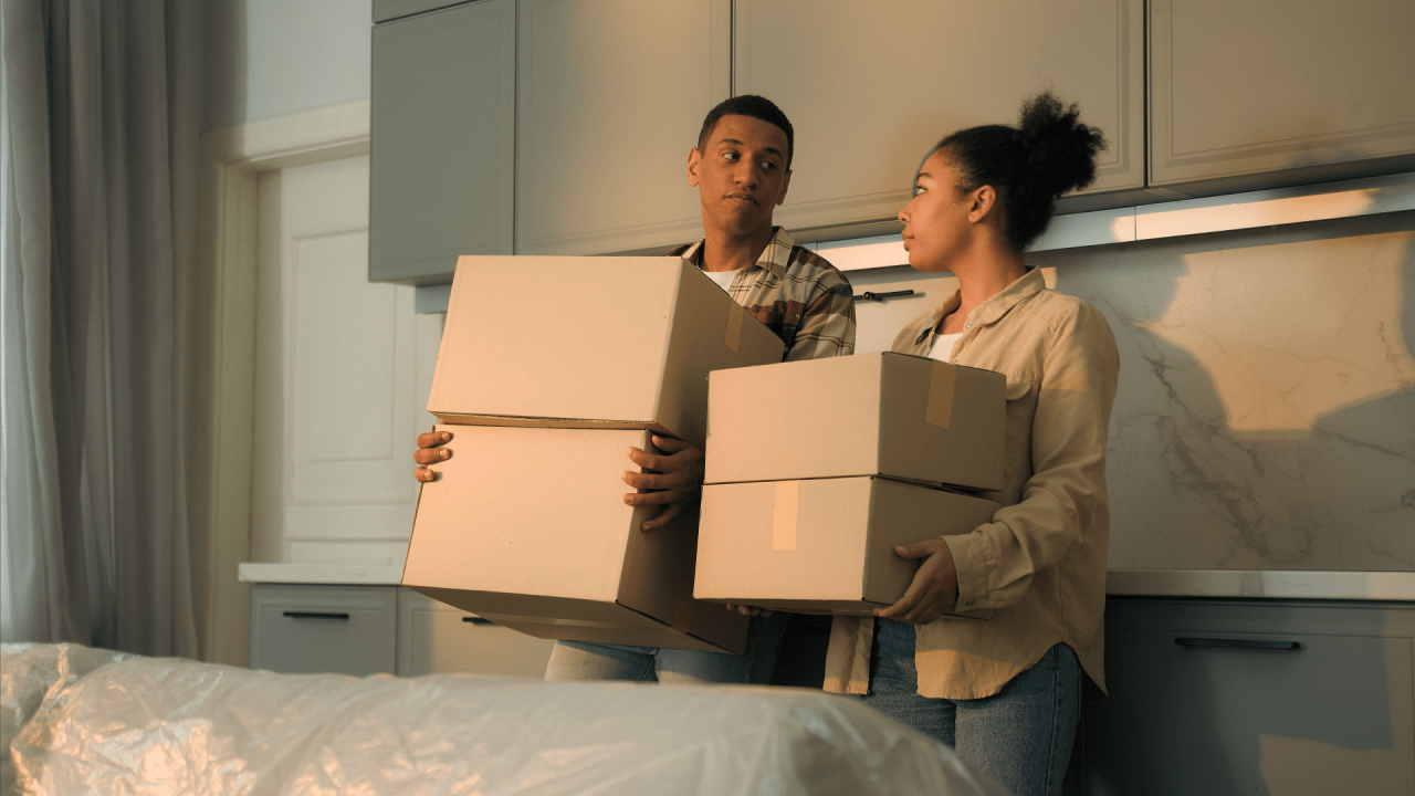 Sad frustrated couple carrying boxes because they might be moving