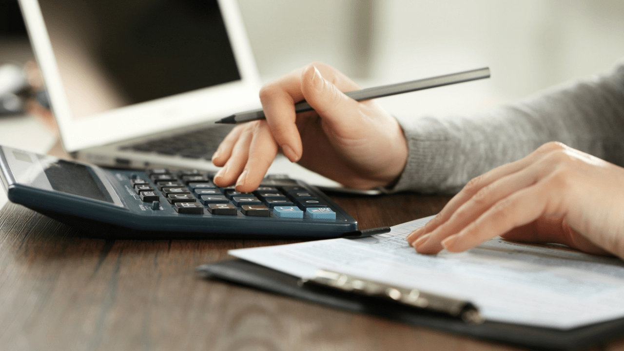 Person reviewing bankruptcy filing options and credit counseling certificate with forms and a calculator nearby