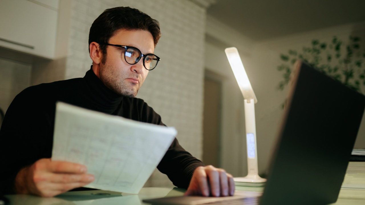 Man reviewing bankruptcy documents and pro se filing forms at home