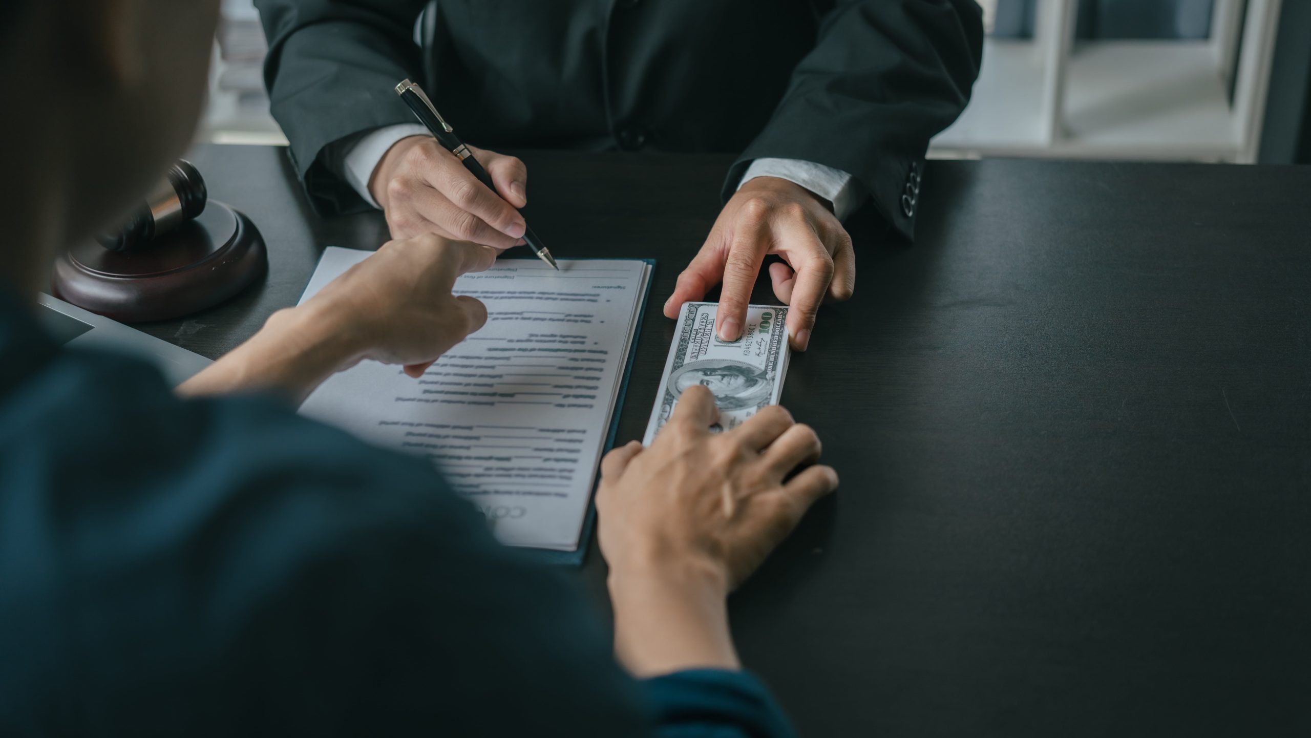 Bankruptcy attorney and client reviewing documents detailing costs to file for Chapter 7 or Chapter 13 bankruptcy