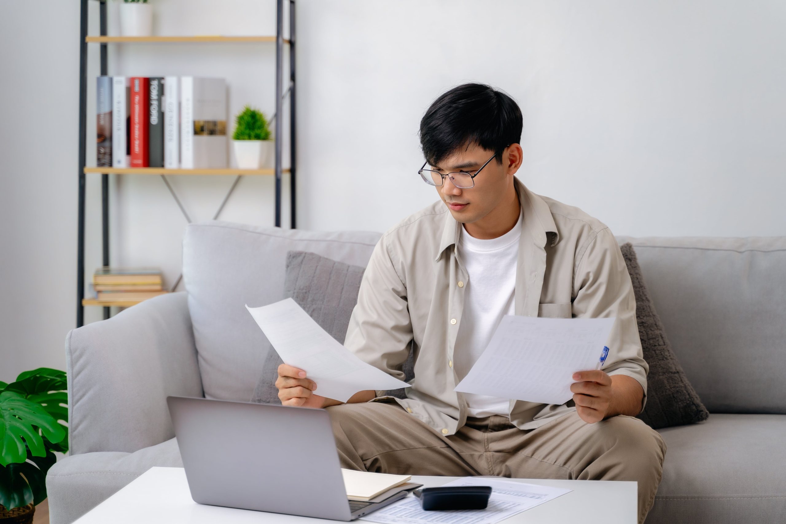 Man reviewing overdue bills and bankruptcy options at home