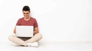 Man reviewing bankruptcy documents at home with laptop open to the U.S. Bankruptcy Court site