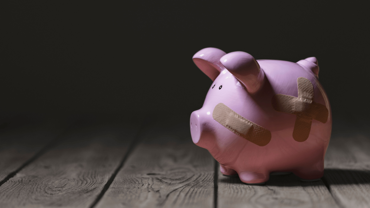 Piggy bank in the dark, seeming lost and broken.