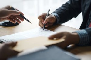 Person signing financial documents for bankruptcy relief