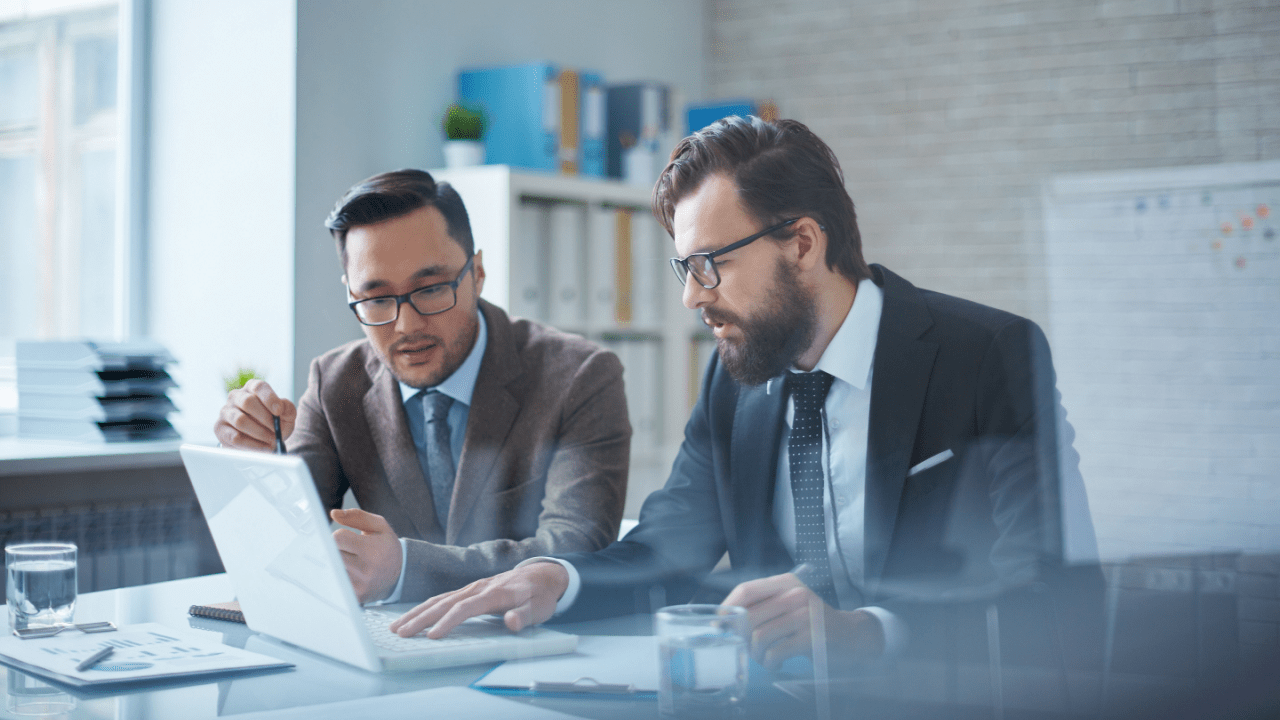 Two bankruptcy attorneys discussing will I lose my home if I file bankruptcy with client documents on desk