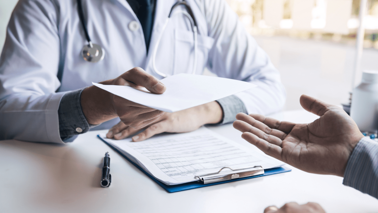 Doctor handing medical bills to patient discussing can i file bankruptcy on medical bills options