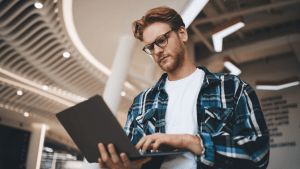 Professional man researching can you keep your home if you file bankruptcy on laptop in modern office