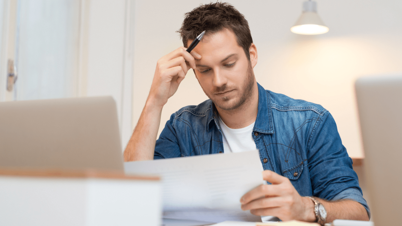Man reviewing bankruptcy paperwork at home