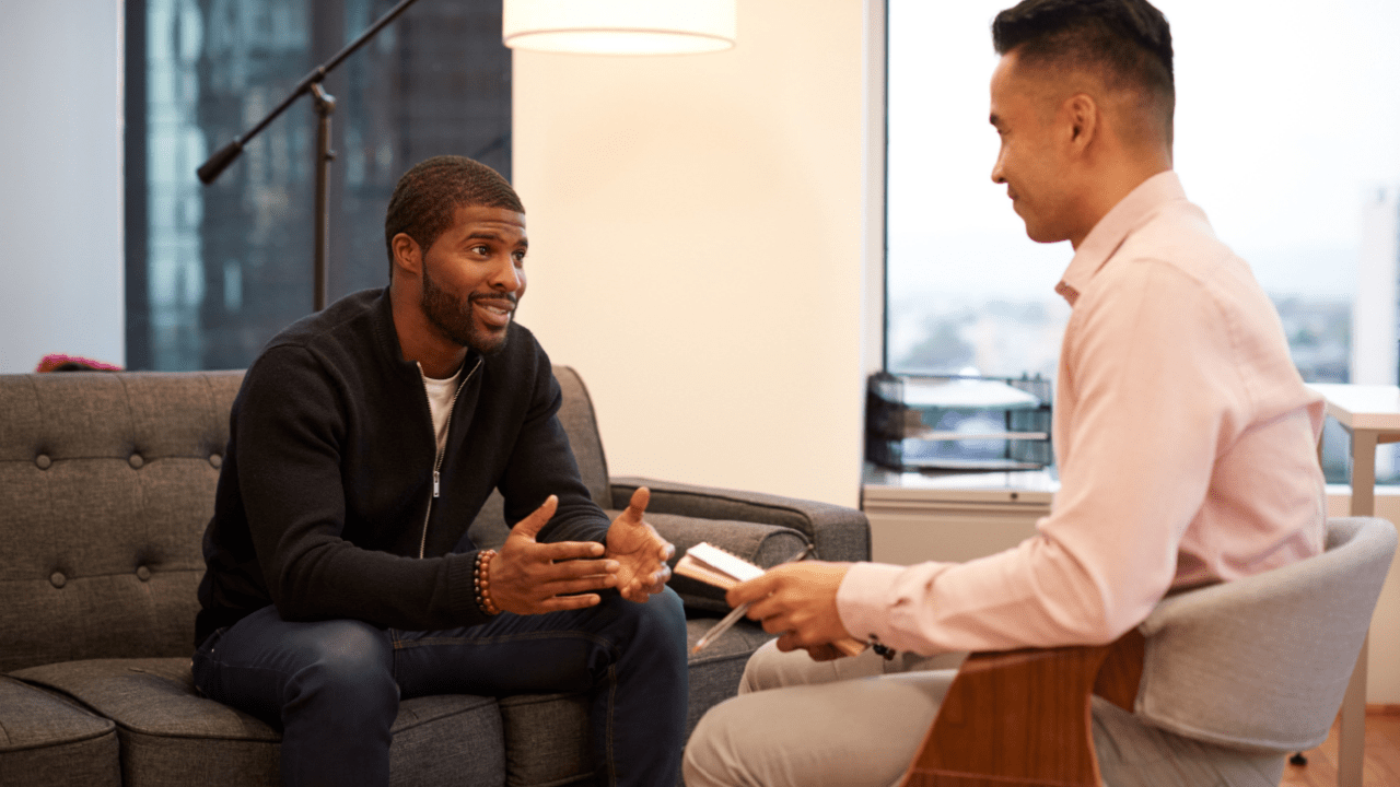 Professional bankruptcy attorney explaining how many times can a person file bankruptcy to client in modern office