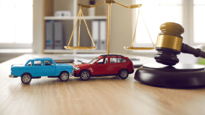 Two toy cars next to scales of justice and gavel representing if i file bankruptcy can i keep my car legal decisions