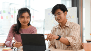 Two people reviewing Chapter 7 bankruptcy assets on tablet to determine what assets do you lose