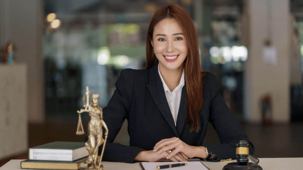Professional female bankruptcy attorney explaining Chapter 7 costs assets and fees at law office desk with legal books and gavel