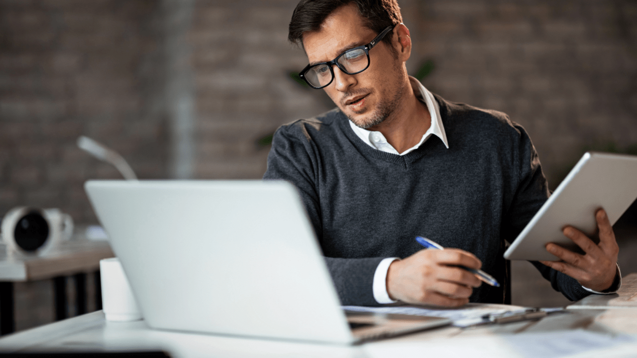 Professional reviewing Chapter 7 eligibility and requirements documentation on laptop and tablet