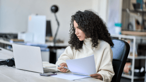 Woman reviewing Chapter 7 bankruptcy documents while researching how much creditors get in Chapter 7 cases