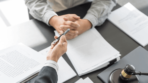 Attorney consultation about whether it is better to file Chapter 7 or 13 bankruptcy with legal documents and gavel on desk