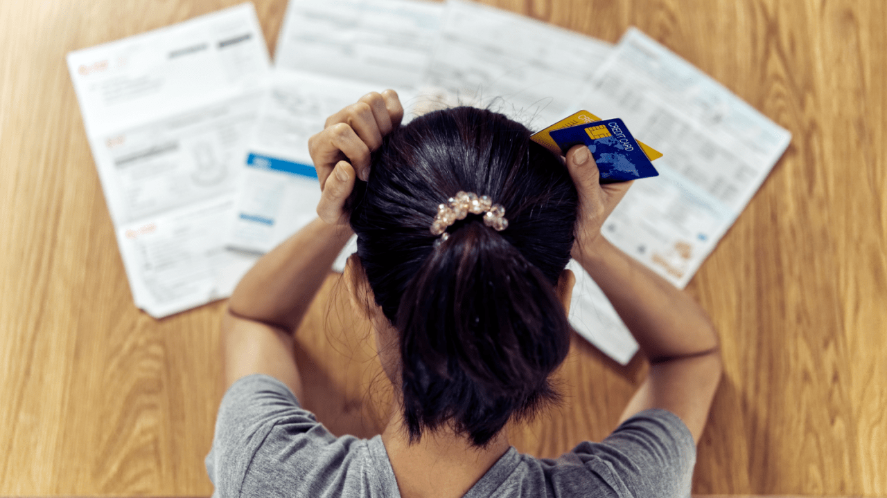 Person stressed about debt wondering what are the three most common types of bankruptcies for financial relief