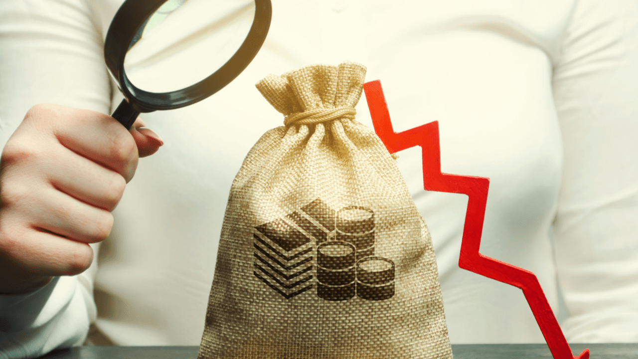 Can you keep everything when filing bankruptcy - magnifying glass examining money bag with declining assets arrow showing bankruptcy exemption protection analysis