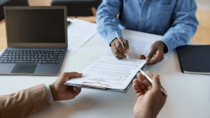 Professional consultation reviewing Chapter 7 vs Chapter 13 bankruptcy paperwork and documents