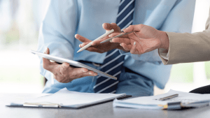 Business professionals reviewing Chapter 13 bankruptcy documents to determine if Chapter 13 is hard to get approved