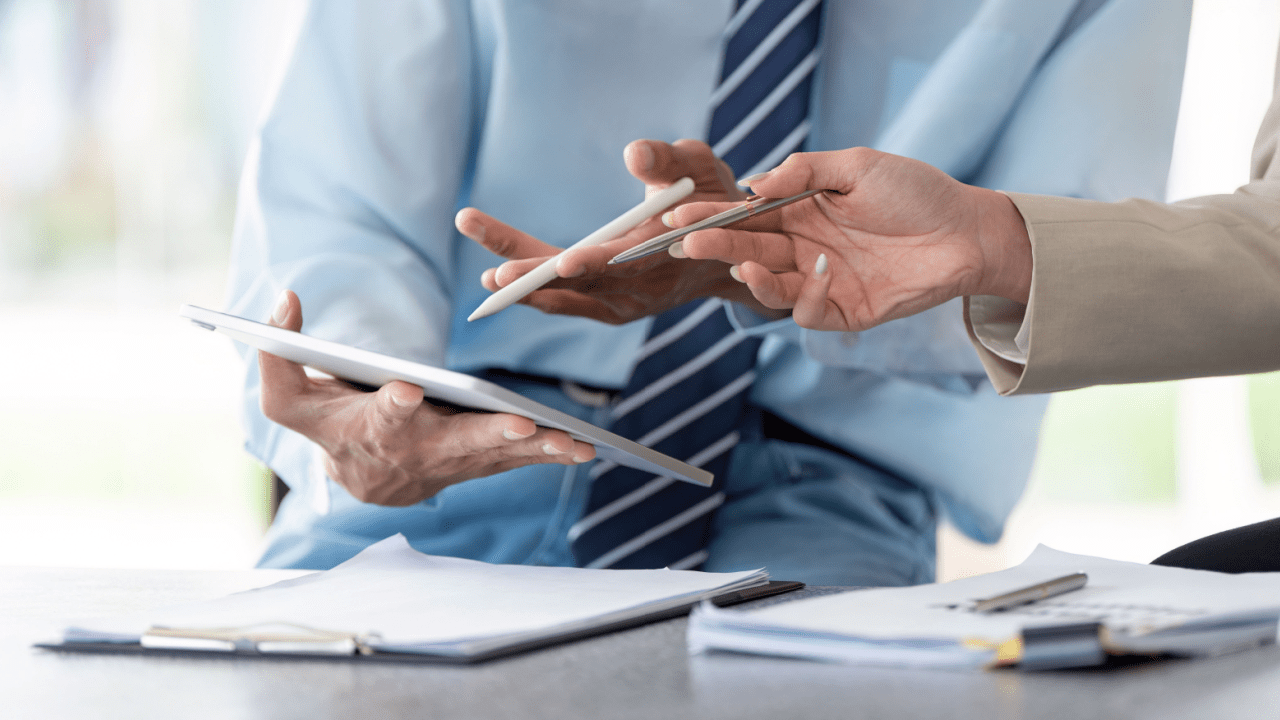 Business professionals reviewing Chapter 13 bankruptcy documents to determine if Chapter 13 is hard to get approved