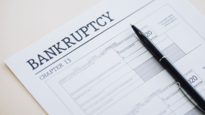 What are the downsides of Chapter 13 bankruptcy forms with pen showing repayment plan documentation and payment schedule requirements