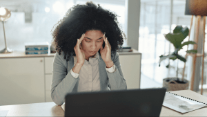 Woman stressed about debt wondering what would disqualify me from Chapter 13 bankruptcy while reviewing financial documents