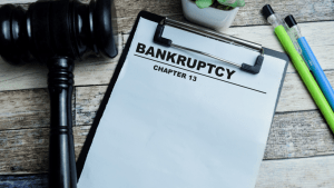 What is the main problem in Chapter 13 bankruptcy clipboard with gavel on wooden desk