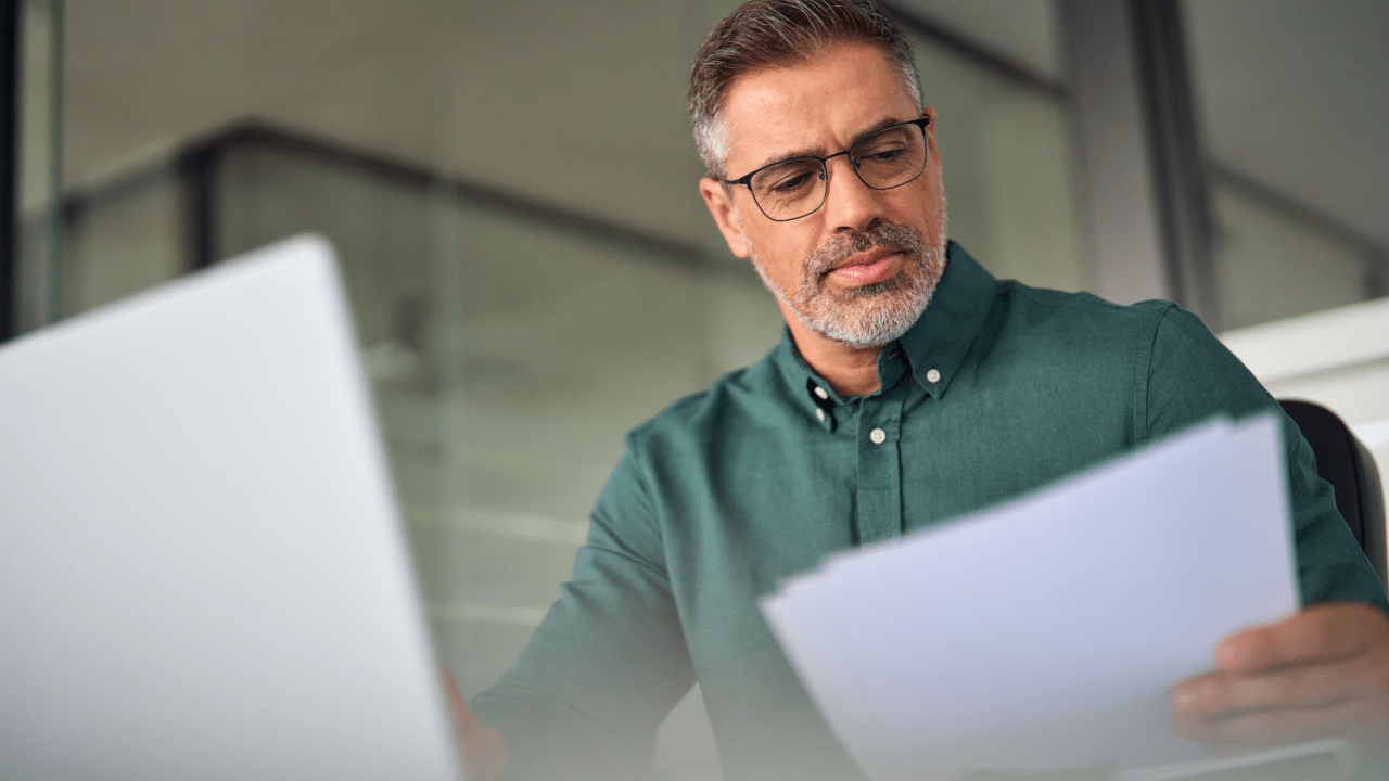 Professional bankruptcy attorney reviewing Chapter 7 denial reasons and legal documents at desk