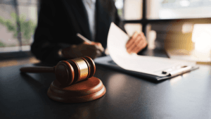 Do you need to have a lawyer to file Chapter 13 bankruptcy attorney reviewing legal documents at desk with gavel