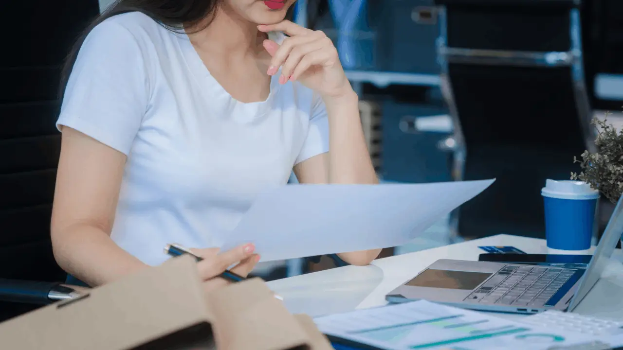 Woman reviewing Chapter 13 bankruptcy documents wondering does Chapter 13 give you a fresh start with financial relief papers