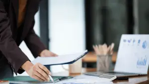 Professional bankruptcy attorney reviewing Chapter 13 repayment plan timeline documents with client during consultation to explain how long does it take to do Chapter 13 bankruptcy