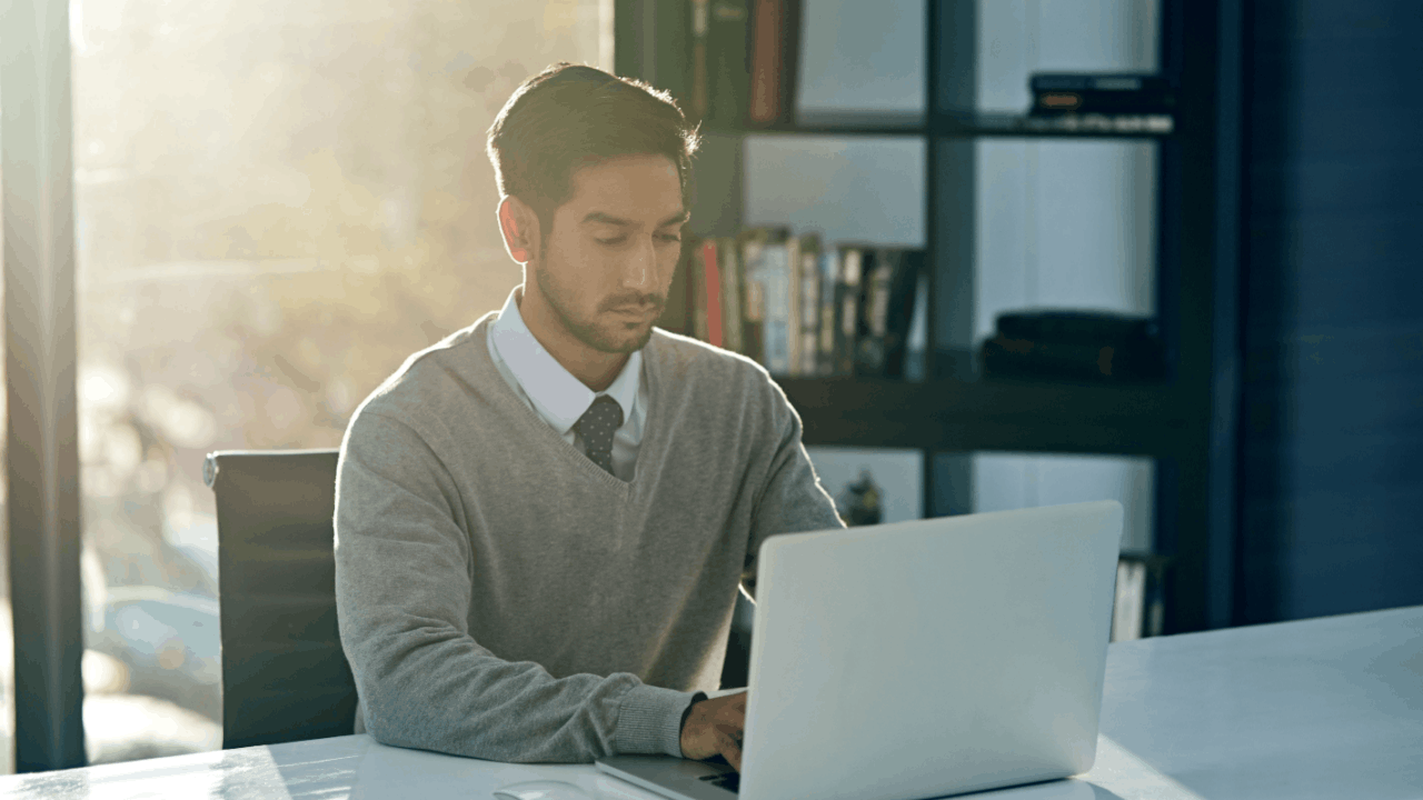 Man considering if it is hard to file Chapter 13 on your own while working on laptop at home