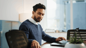 Man researching what you lose in a Chapter 13 bankruptcy on laptop at home office