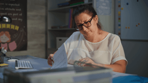 Woman reviewing financial documents learning what not to do before Chapter 13 bankruptcy filing