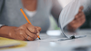 Person reviewing Chapter 13 bankruptcy paperwork considering the downside to filing Chapter 13 with attorney consultation