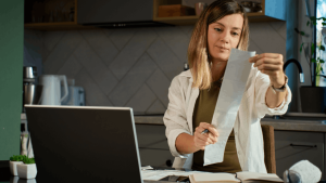 What qualifies you for Chapter 13 bankruptcy - woman reviewing financial documents and eligibility requirements at home