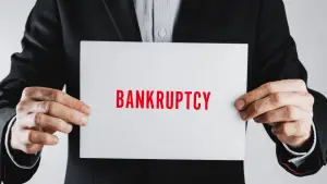 Chapter 13 attorney holding bankruptcy sign representing legal representation for debt reorganization cases