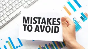 Chapter 13 mistakes to avoid sign held over financial charts and keyboard representing bankruptcy planning errors