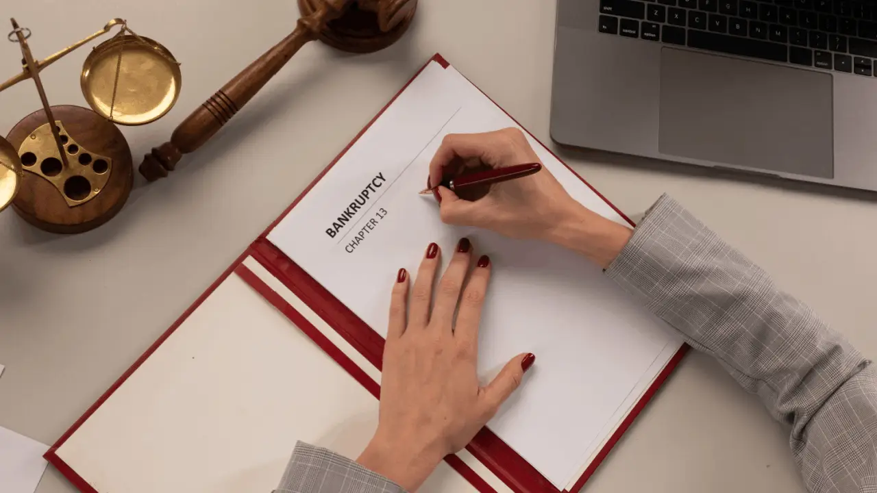 Person reviewing Chapter 13 bankruptcy forms to file without an attorney