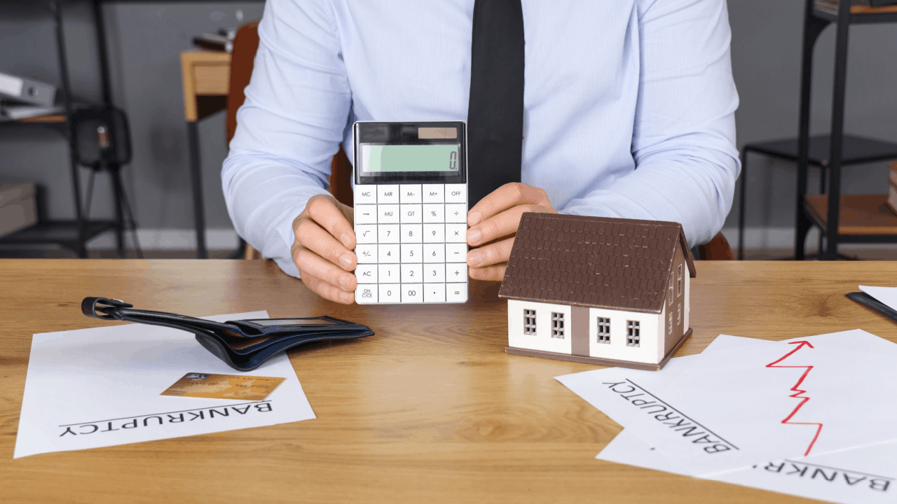 What cannot be wiped out by the concept of bankruptcies with a calculator, a house model, and bankruptcy documents on a desk