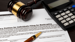 Does chapter 13 erase all debt - bankruptcy petition form with gavel calculator and pen on desk