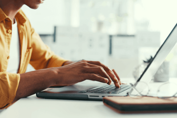 Person typing on a laptop researching is chapter 11 good or bad for their financial situation