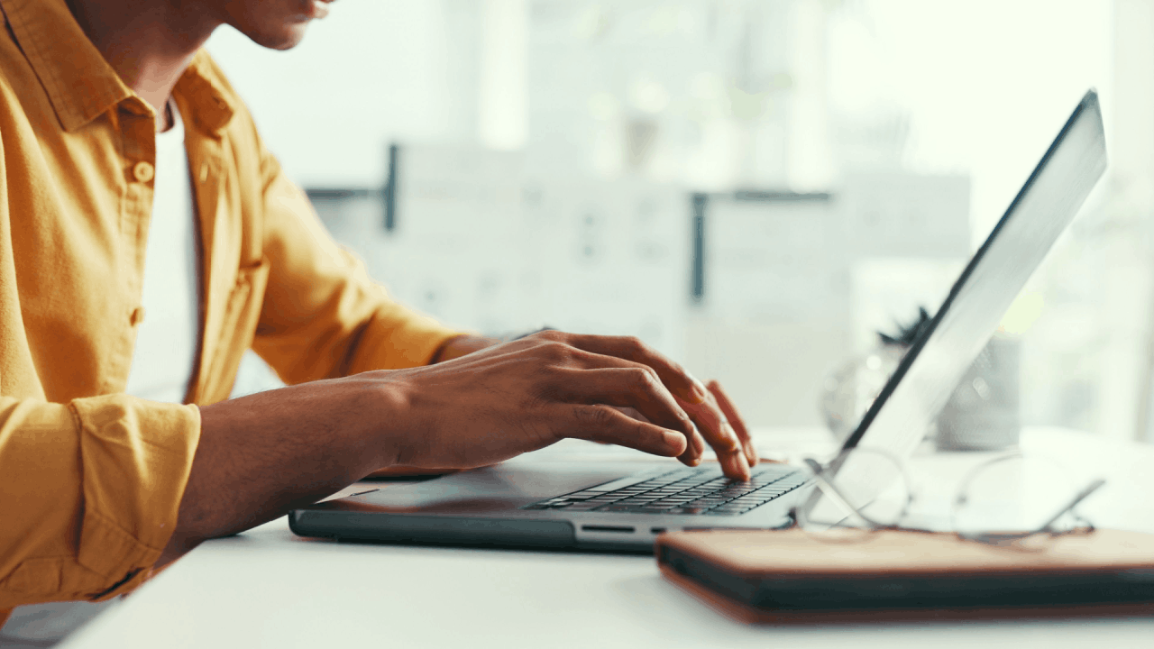 Person typing on a laptop researching is chapter 11 good or bad for their financial situation