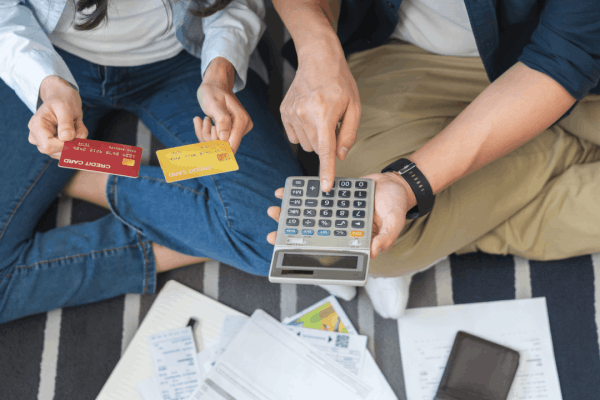 is chapter 7 better than chapter 11 — couple reviewing credit card debt with calculator