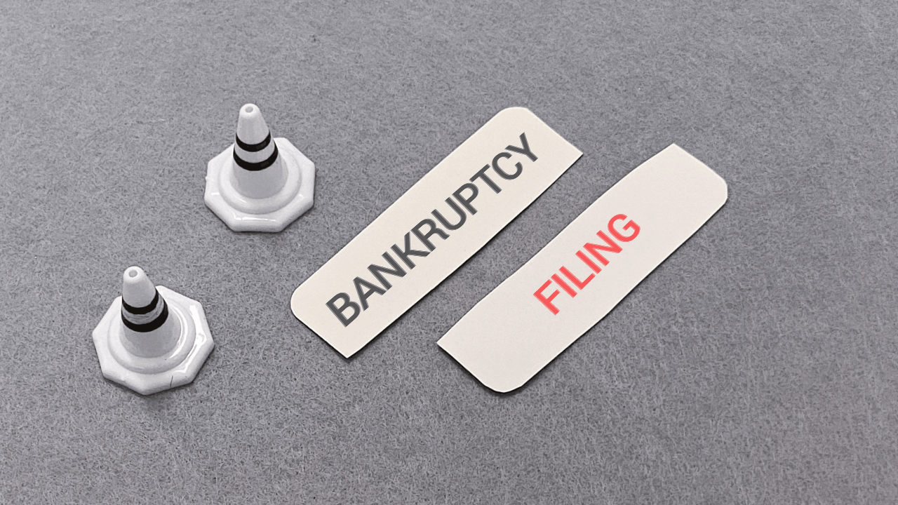 Is it better to file a chapter 11 or 13 bankruptcy decision with filing cards and warning cones on gray surface