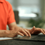 Person researching what two debts cannot be erased in bankruptcy on a laptop with financial documents nearby