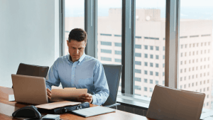 Attorney reviewing legal documents in a high-rise office to explain what's the difference between chapter 7 and 11 bankruptcy