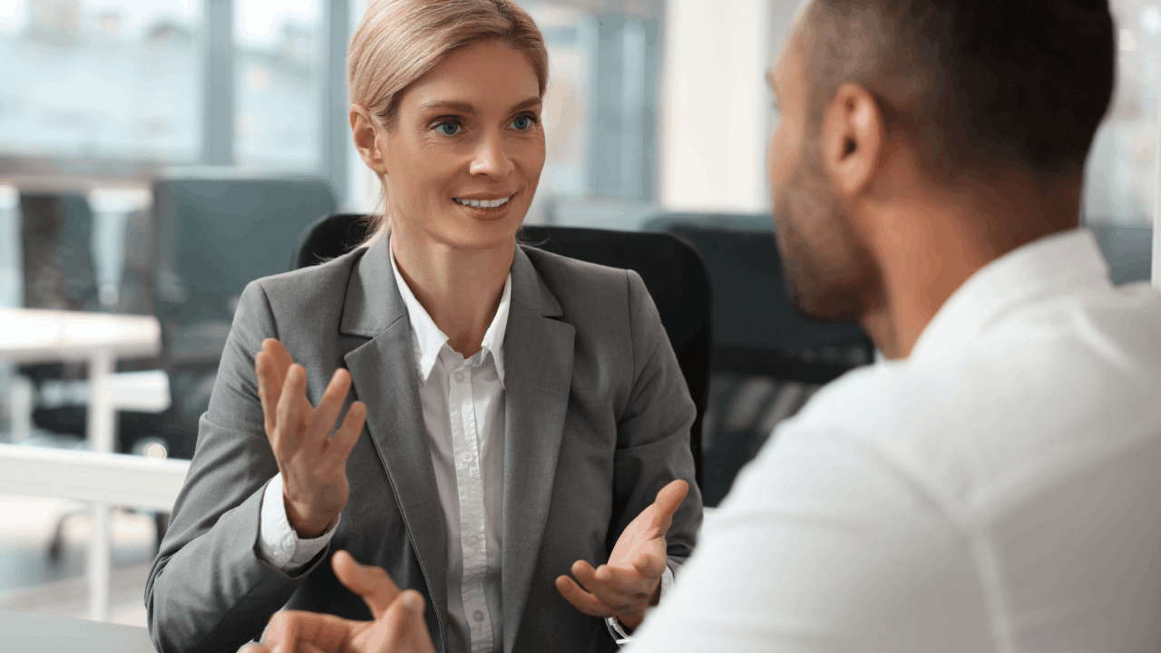 Professional consultant explaining which is better chapter 11 or 13 bankruptcy options to a client in a modern office