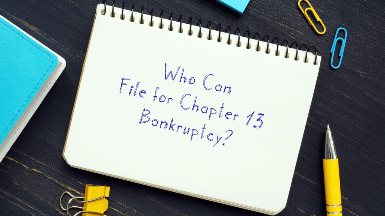 Who is eligible for chapter 13 handwritten question on notepad with pen paperclips and office supplies on dark desk