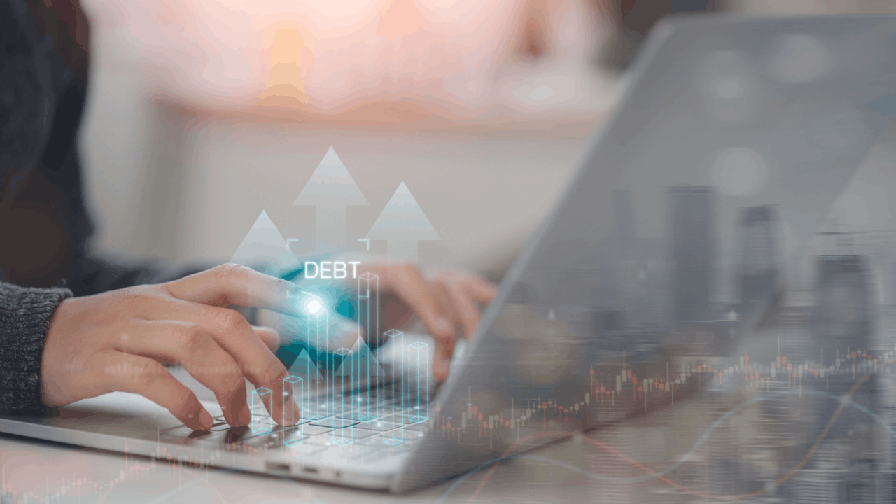 Does all your debt go away with bankruptcy — person researching debt discharge options on laptop